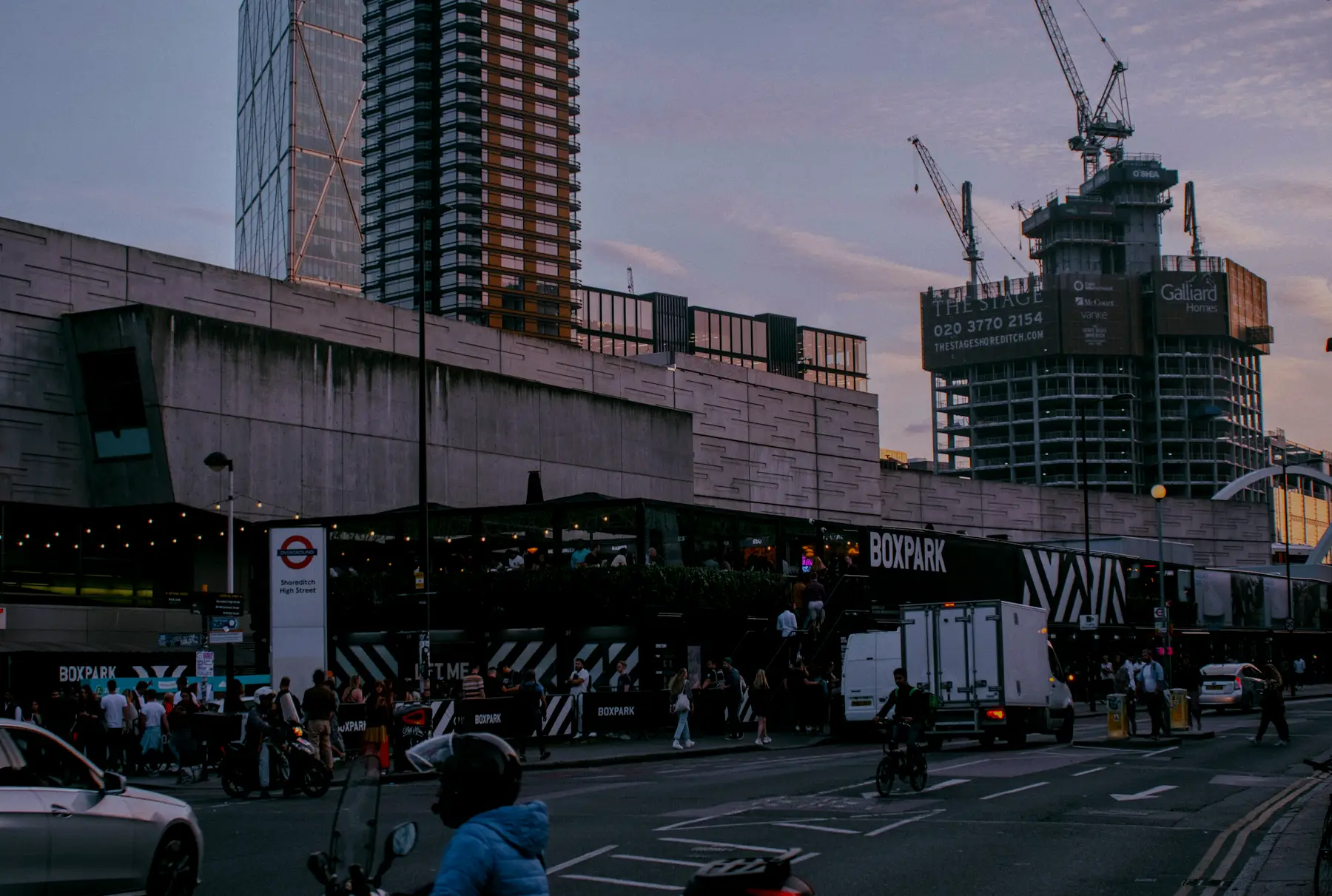Boxpark Shoreditch and the Shoreditch High Street Overground sign at dusk