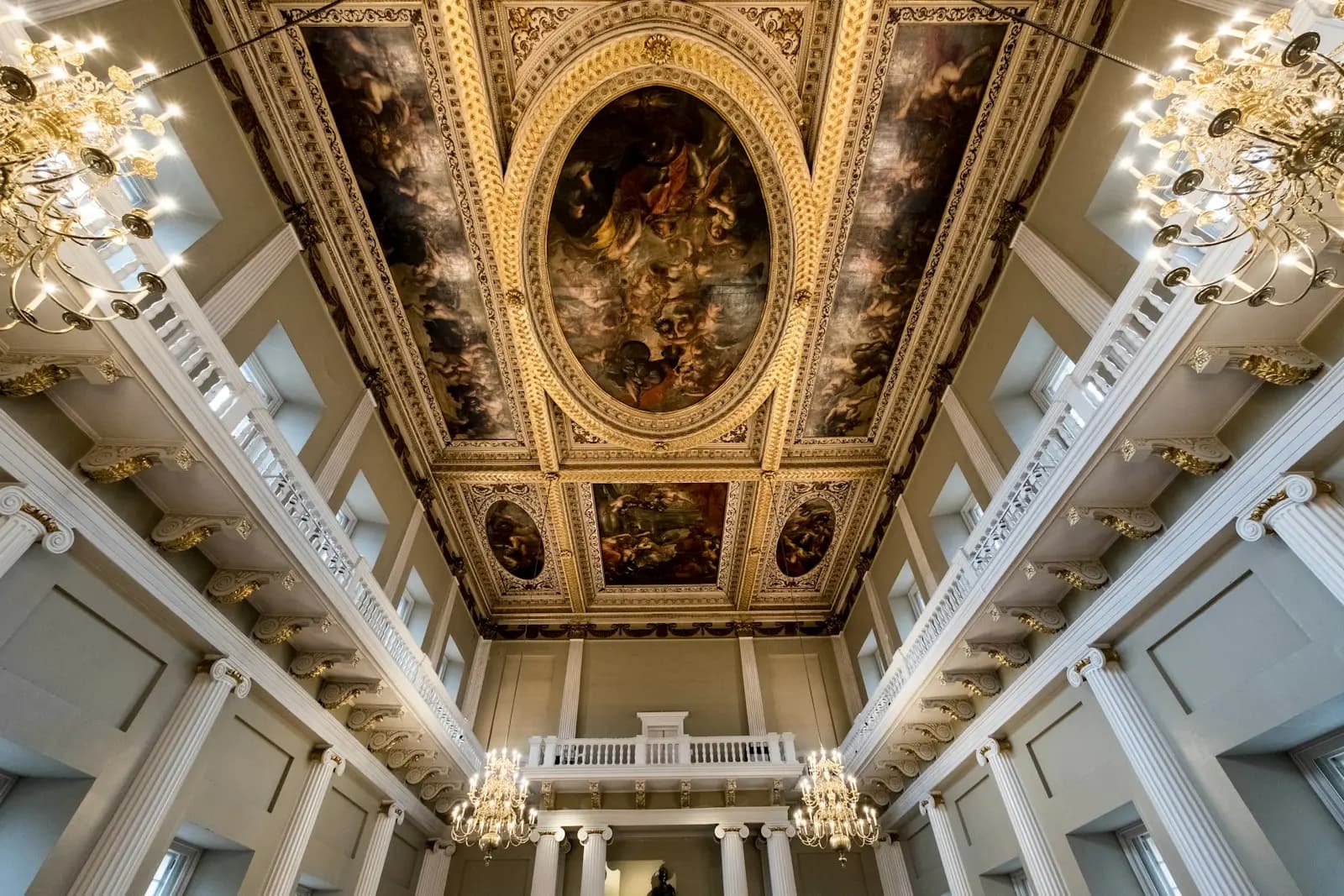 A painted ceiling, gilded galleries and chandeliers in a London state room
